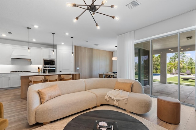 8105 Fenton St, Orlando, FL 32836 - living room with a chandelier, light wood-style floors, and recessed lighting