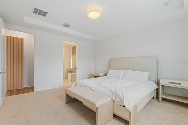 8105 Fenton St, Orlando, FL 32836 - bedroom featuring a tray ceiling, light carpet, baseboards, and ensuite bathroom