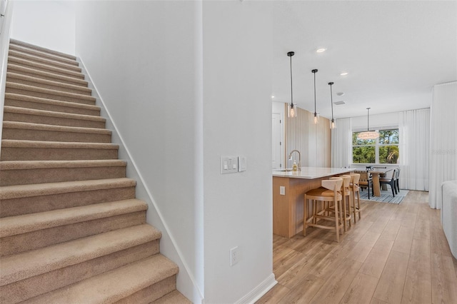 8105 Fenton St, Orlando, FL 32836 - stairs featuring wood finished floors, recessed lighting, and baseboards