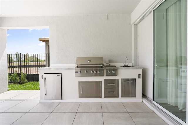 8105 Fenton St, Orlando, FL 32836 - view of patio featuring area for grilling, exterior kitchen, a sink, and fence