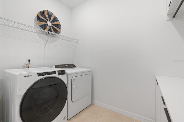 8105 Fenton St, Orlando, FL 32836 - clothes washing area with washing machine and dryer, baseboards, and light tile patterned floors