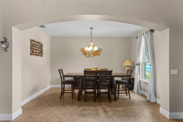 408 Egret Place Dr, Winter Garden, FL 34787 - tiled dining space featuring a chandelier, baseboards, and arched walkways