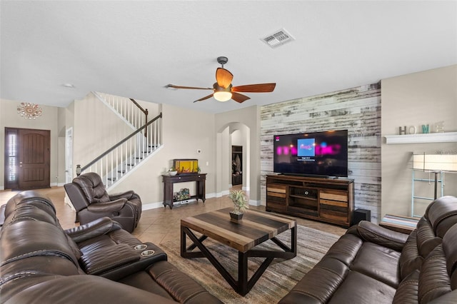408 Egret Place Dr, Winter Garden, FL 34787 - living room featuring ceiling fan, arched walkways, stairs, baseboards, and tile patterned floors