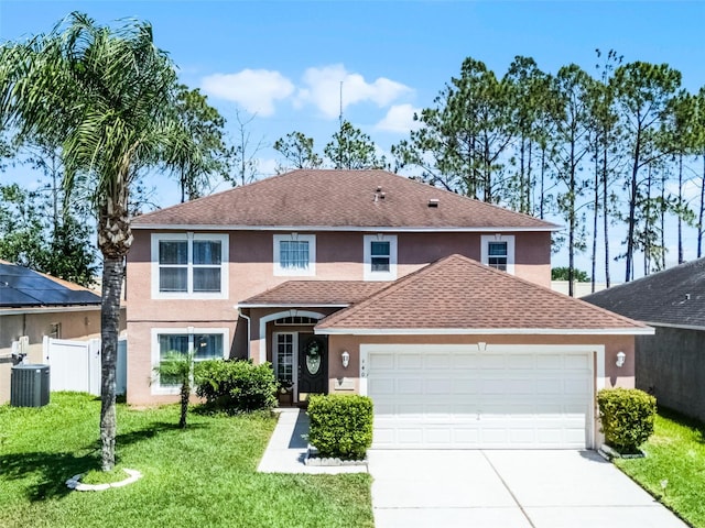 traditional-style house with driveway, central AC unit, a garage, fence, and stucco siding