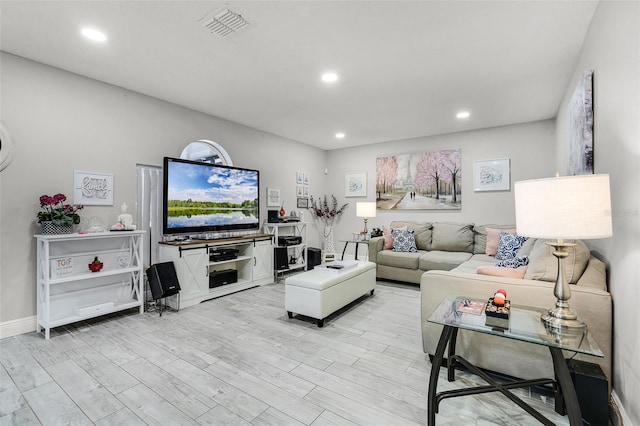 living area with recessed lighting, visible vents, and light wood-style flooring