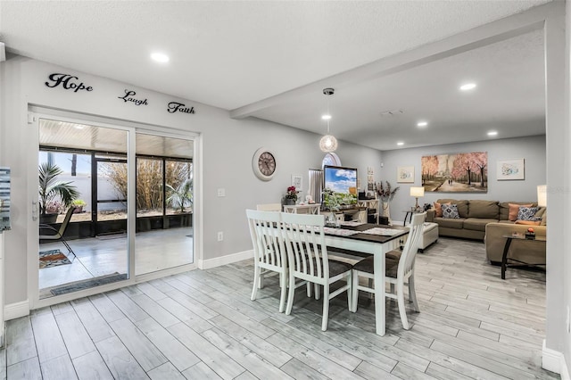 dining room with recessed lighting, baseboards, and light wood finished floors