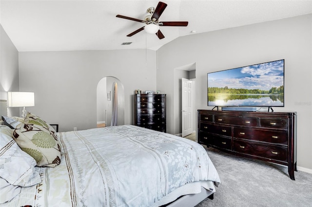 bedroom with ceiling fan, visible vents, carpet floors, arched walkways, and vaulted ceiling