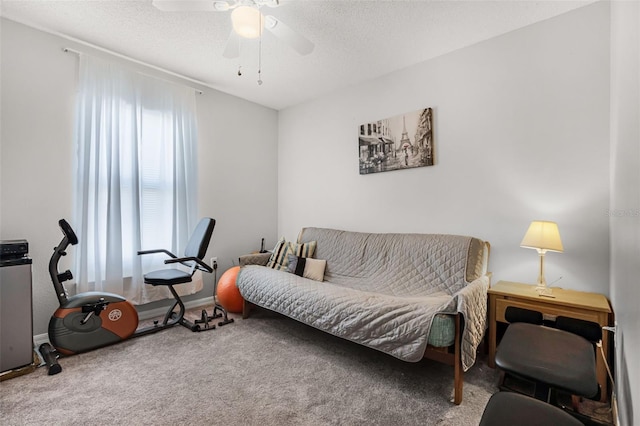 interior space with a ceiling fan and a textured ceiling