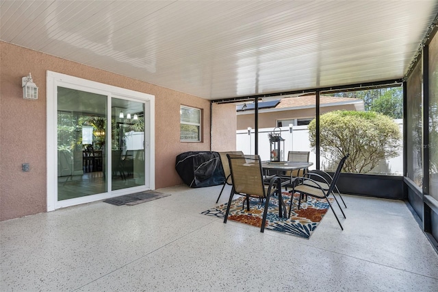 sunroom / solarium with outdoor dining area