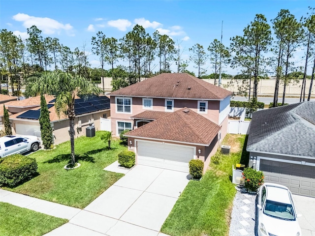 traditional-style home featuring fence, a shingled roof, a front lawn, stucco siding, and driveway