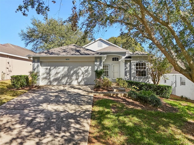 single story home featuring a garage, stucco siding, and concrete driveway
