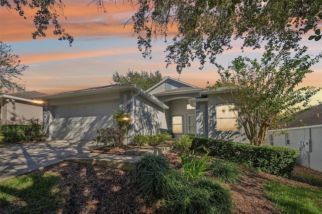 view of front facade featuring an attached garage, stucco siding, and concrete driveway