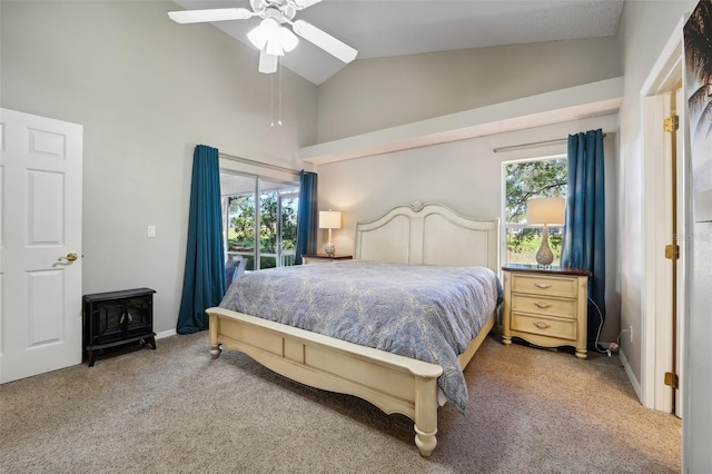 carpeted bedroom with ceiling fan, access to exterior, a wood stove, high vaulted ceiling, and baseboards
