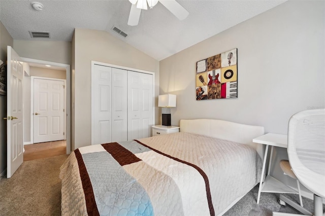carpeted bedroom featuring visible vents, a ceiling fan, lofted ceiling, and a closet
