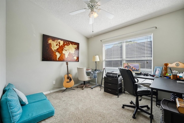 home office featuring carpet flooring, a textured ceiling, a ceiling fan, baseboards, and vaulted ceiling