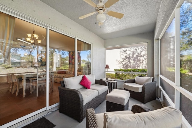 sunroom with an outdoor hangout area and ceiling fan with notable chandelier