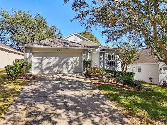 ranch-style house with a garage, a front lawn, and concrete driveway