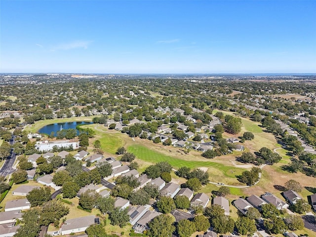 drone / aerial view with a residential view, view of golf course, and a water view