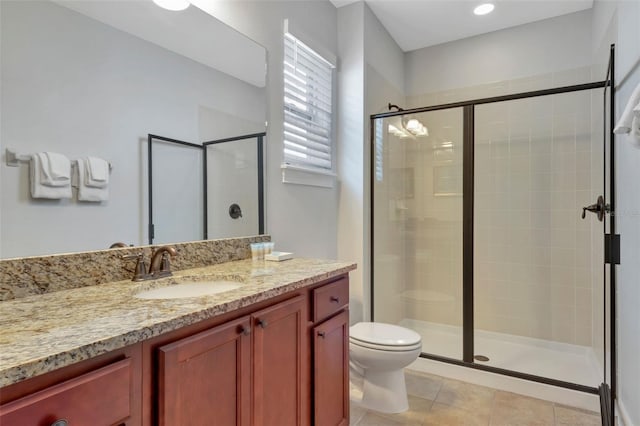 7643 Wilmington Loop, Kissimmee, FL 34747 - bathroom with a stall shower, tile patterned floors, vanity, and toilet