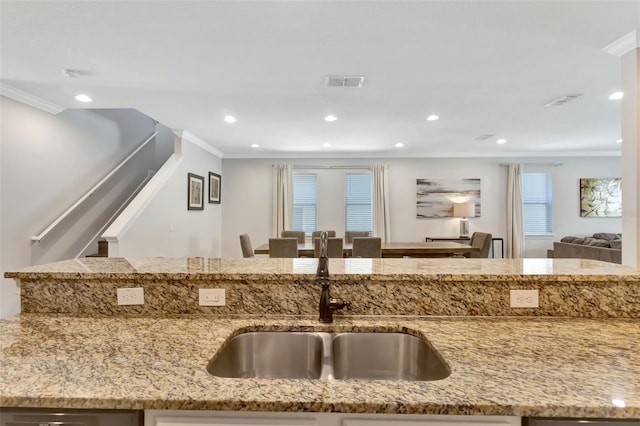 7643 Wilmington Loop, Kissimmee, FL 34747 - kitchen featuring visible vents, light stone countertops, ornamental molding, and a sink