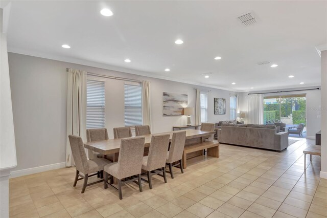 7643 Wilmington Loop, Kissimmee, FL 34747 - dining area with ornamental molding, light tile patterned floors, visible vents, and recessed lighting