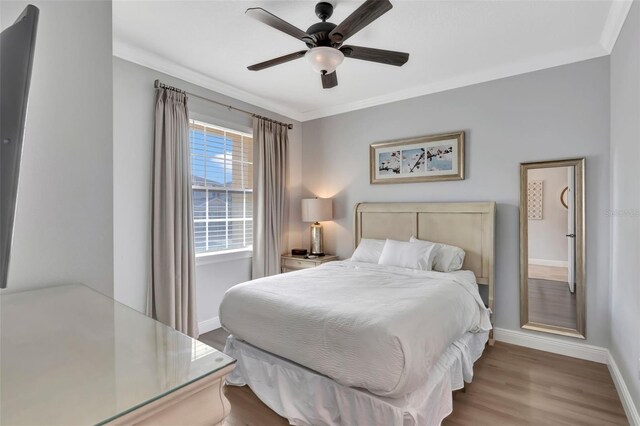 7643 Wilmington Loop, Kissimmee, FL 34747 - bedroom with baseboards, ornamental molding, a ceiling fan, and wood finished floors