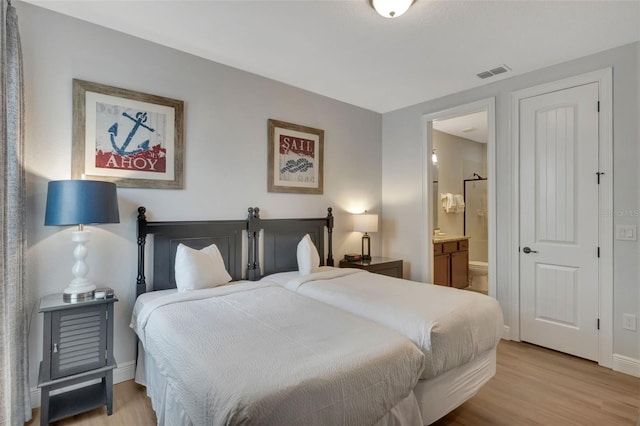 7643 Wilmington Loop, Kissimmee, FL 34747 - bedroom featuring connected bathroom, visible vents, light wood-style flooring, and baseboards