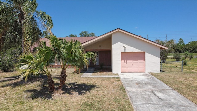 857 E Flag Ln, Kissimmee, FL 34759 - view of front of property with driveway, fence, an attached garage, stucco siding, and a front lawn