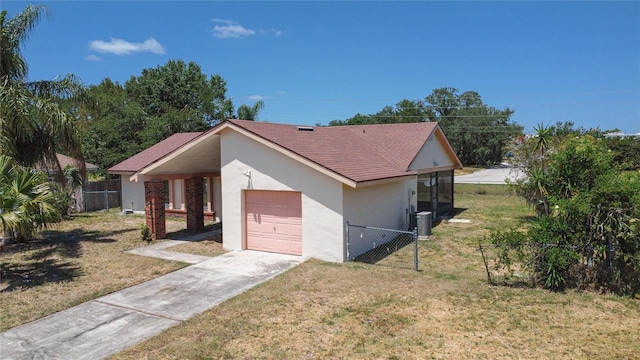 857 E Flag Ln, Kissimmee, FL 34759 - view of side of home with a yard, fence, a garage, stucco siding, and concrete driveway