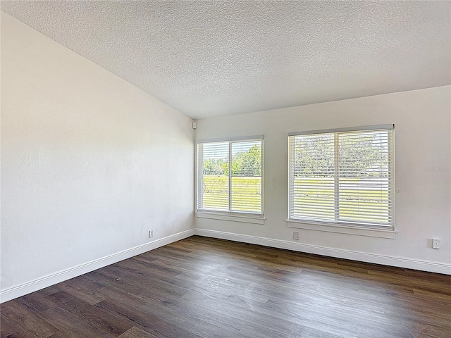 857 E Flag Ln, Kissimmee, FL 34759 - empty room with a textured ceiling, baseboards, and dark wood-type flooring
