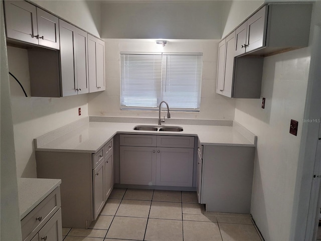 936 Pinedale Ave, Orlando, FL 32808 - kitchen with gray cabinetry, light tile patterned flooring, and a sink