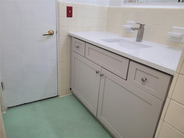 936 Pinedale Ave, Orlando, FL 32808 - bathroom with tile patterned floors, tile walls, and vanity