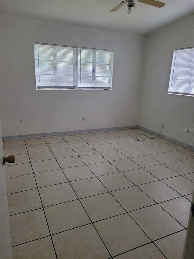 936 Pinedale Ave, Orlando, FL 32808 - empty room featuring light tile patterned floors, baseboards, and ceiling fan