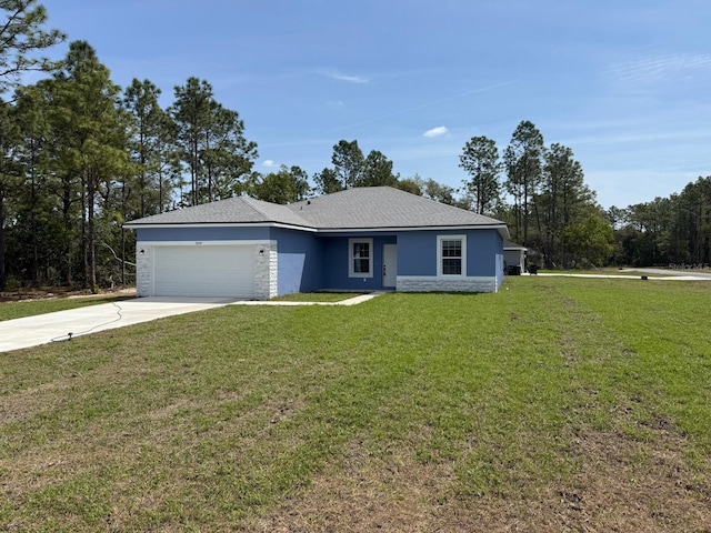 single story home with an attached garage, stone siding, stucco siding, a front yard, and concrete driveway