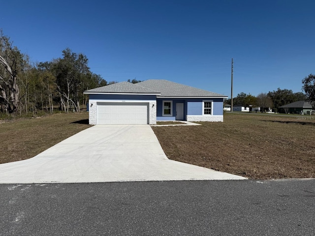 ranch-style house with a garage, concrete driveway, and a front yard