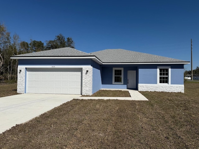 ranch-style home with an attached garage, a front lawn, stucco siding, and concrete driveway