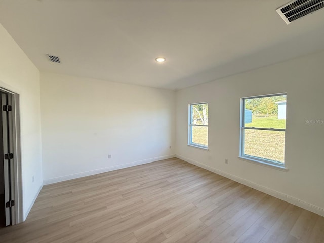 spare room featuring recessed lighting, baseboards, visible vents, and light wood-style floors