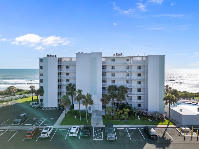 5301 S Atlantic Ave Unit 51, New Smyrna Beach, FL 32169 - view of building exterior with a water view and uncovered parking