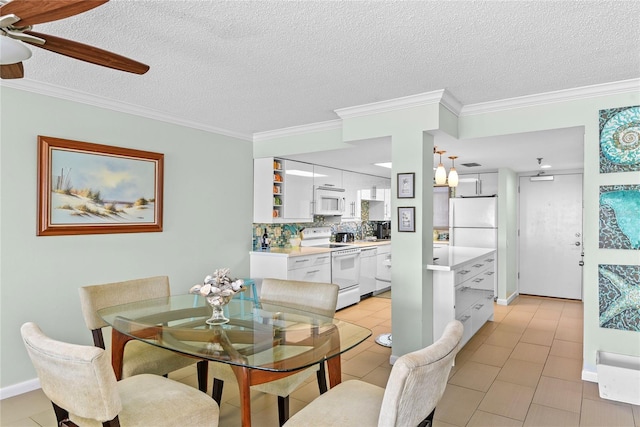 5301 S Atlantic Ave Unit 51, New Smyrna Beach, FL 32169 - dining space featuring a ceiling fan, a textured ceiling, light tile patterned floors, and ornamental molding