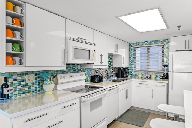 5301 S Atlantic Ave Unit 51, New Smyrna Beach, FL 32169 - kitchen featuring a sink, light countertops, white appliances, and white cabinetry