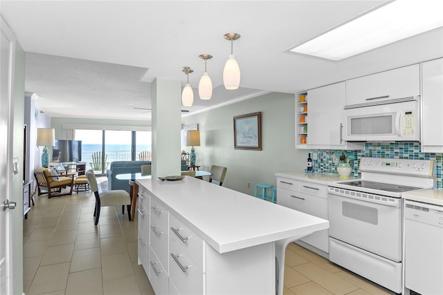 5301 S Atlantic Ave Unit 51, New Smyrna Beach, FL 32169 - kitchen with decorative backsplash, light countertops, light tile patterned floors, white cabinets, and white appliances