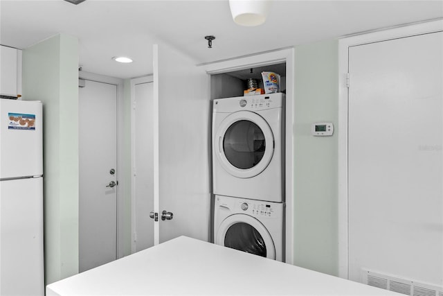 5301 S Atlantic Ave Unit 51, New Smyrna Beach, FL 32169 - laundry room featuring stacked washer and dryer, laundry area, and visible vents