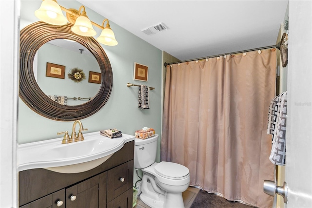5301 S Atlantic Ave Unit 51, New Smyrna Beach, FL 32169 - bathroom featuring visible vents, tile patterned flooring, vanity, toilet, and a shower with shower curtain