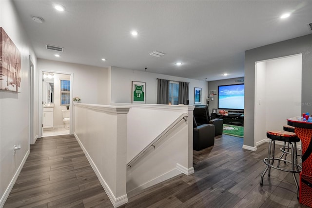 555 Meadow Bend Dr, Davenport, FL 33837 - hallway with an upstairs landing, dark wood finished floors, baseboards, and recessed lighting