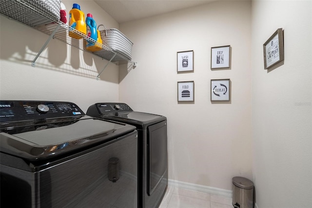555 Meadow Bend Dr, Davenport, FL 33837 - washroom featuring washing machine and dryer, baseboards, and light tile patterned floors