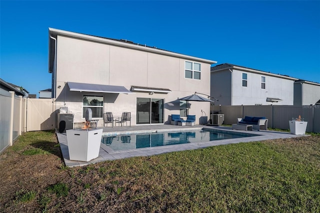 555 Meadow Bend Dr, Davenport, FL 33837 - rear view of property featuring stucco siding, a patio area, an outdoor hangout area, and cooling unit