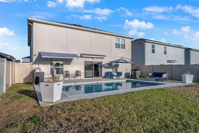 555 Meadow Bend Dr, Davenport, FL 33837 - back of house featuring stucco siding, an outdoor living space, and a patio