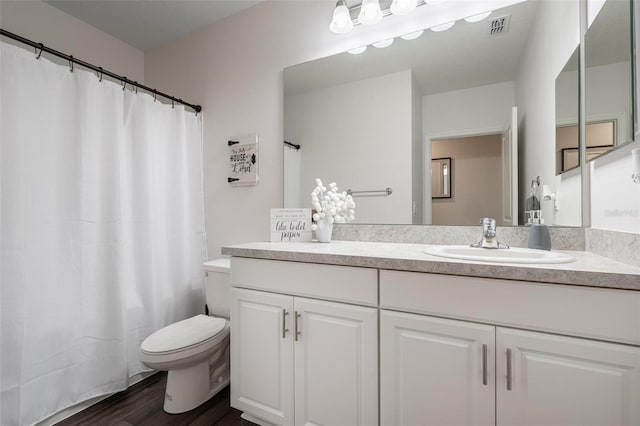 555 Meadow Bend Dr, Davenport, FL 33837 - bathroom with toilet, wood finished floors, and vanity
