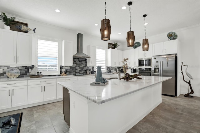 7 Marden Dr, Ormond Beach, FL 32176 - kitchen with stainless steel appliances, wall chimney range hood, tasteful backsplash, a kitchen island with sink, and crown molding