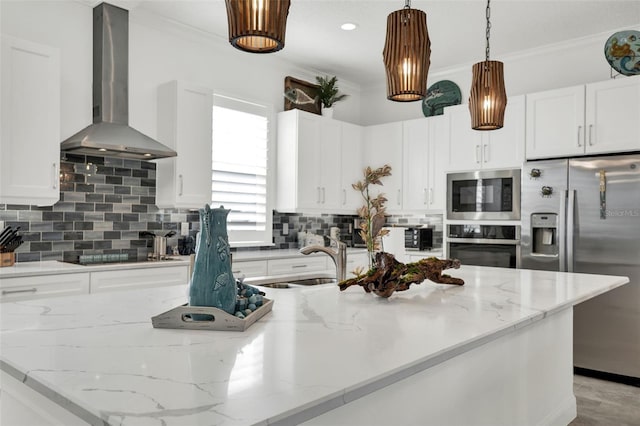 7 Marden Dr, Ormond Beach, FL 32176 - kitchen with wall chimney range hood, appliances with stainless steel finishes, white cabinetry, crown molding, and hanging light fixtures